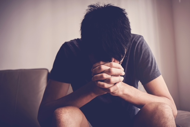 Depressed, despair and anxiety young man sitting alone and praying at home, mental health, men health, praying christian concept